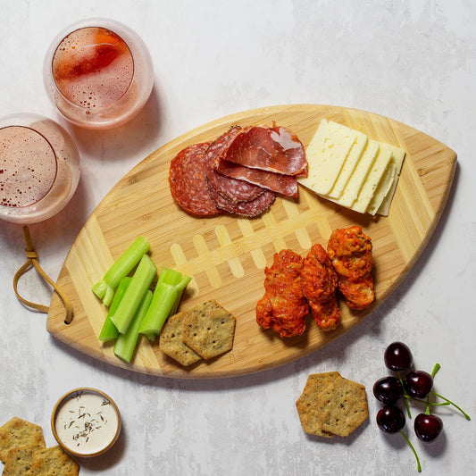 Football Shaped Bamboo Wood Cutting Board and Charcuterie Board, Great Gift for Football Fans | Football serving board for game day watch parties and tailgating. Smooth reverse side for prep. Hangs as decor between uses.