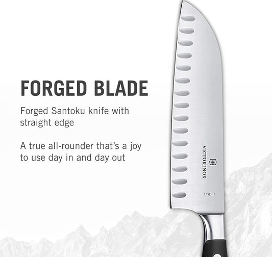 Grand Maître 7" Santoku Knife - Forged Granton Edge Prep Tool | Professional ergonomic kitchen knife with fluted blade for effortless chopping. Features a balanced forged black handle