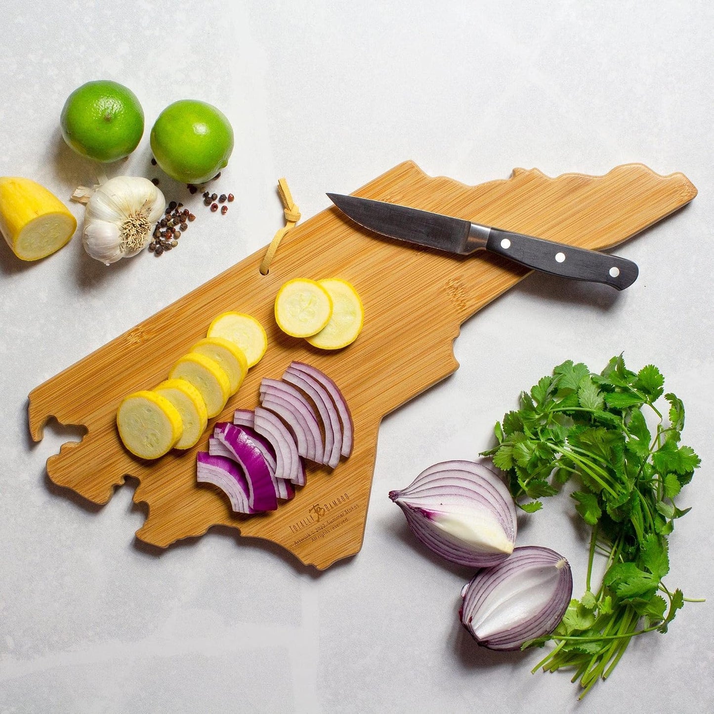 North Carolina State Shaped Cutting Board, Summer Stokes Art | State charcuterie board with colorful hand-drawn landscape art. Smooth reverse side for food prep. Hang tie for wall display. - Colors A