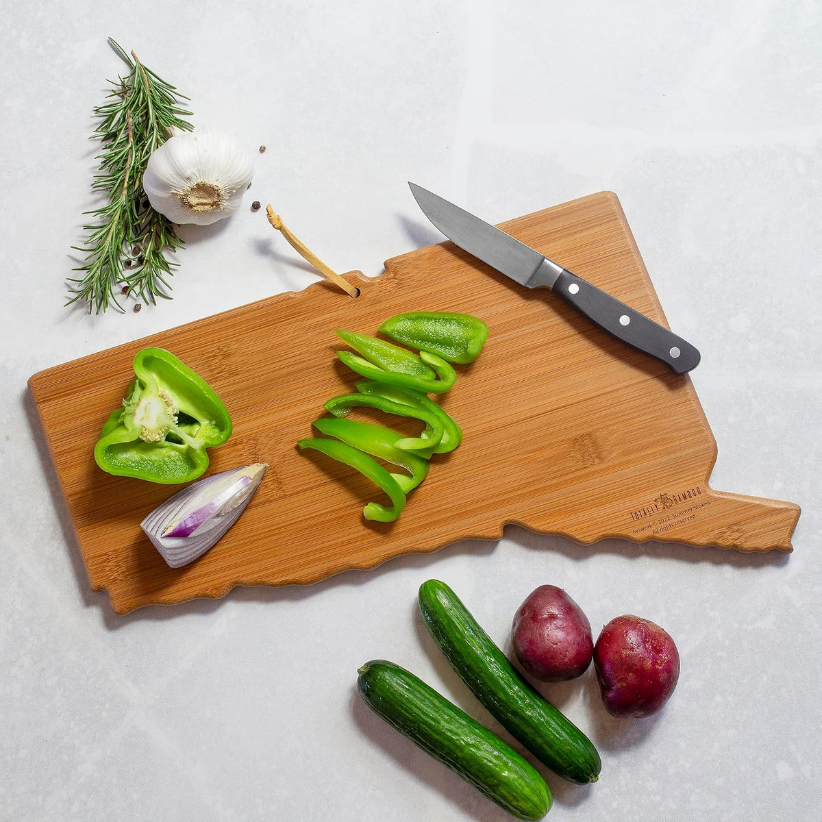 North Carolina State Shaped Cutting Board, Summer Stokes Art | State charcuterie board with colorful hand-drawn landscape art. Smooth reverse side for food prep. Hang tie for wall display. - Colors A