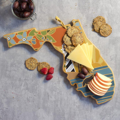 North Carolina State Shaped Cutting Board, Summer Stokes Art | State charcuterie board with colorful hand-drawn landscape art. Smooth reverse side for food prep. Hang tie for wall display. - Colors A