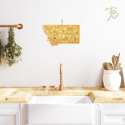 Destination Montana State Shaped Cutting Board | State charcuterie serving board with engraved map artwork. Smooth reverse side for food prep. Hang tie for wall display.