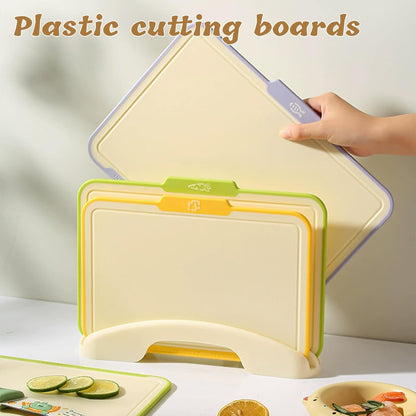 Plastic Cutting Boards for Kitchen, 4-Pieces Cutting Board With Food Icons And Storage Stand, Easy Grip Handle, Professional Chopping Board Set for Meat, Veggies, Fruits（12.9"X 9.4" X 3.1")