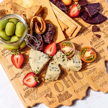 Destination Ohio State Shaped Cutting Board | State charcuterie serving board with engraved map artwork. Smooth reverse side for food prep. Hang tie for wall display.