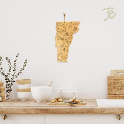 Destination Vermont State Shaped Cutting Board | State charcuterie serving board with engraved map artwork. Smooth reverse side for food prep. Hang tie for wall display.