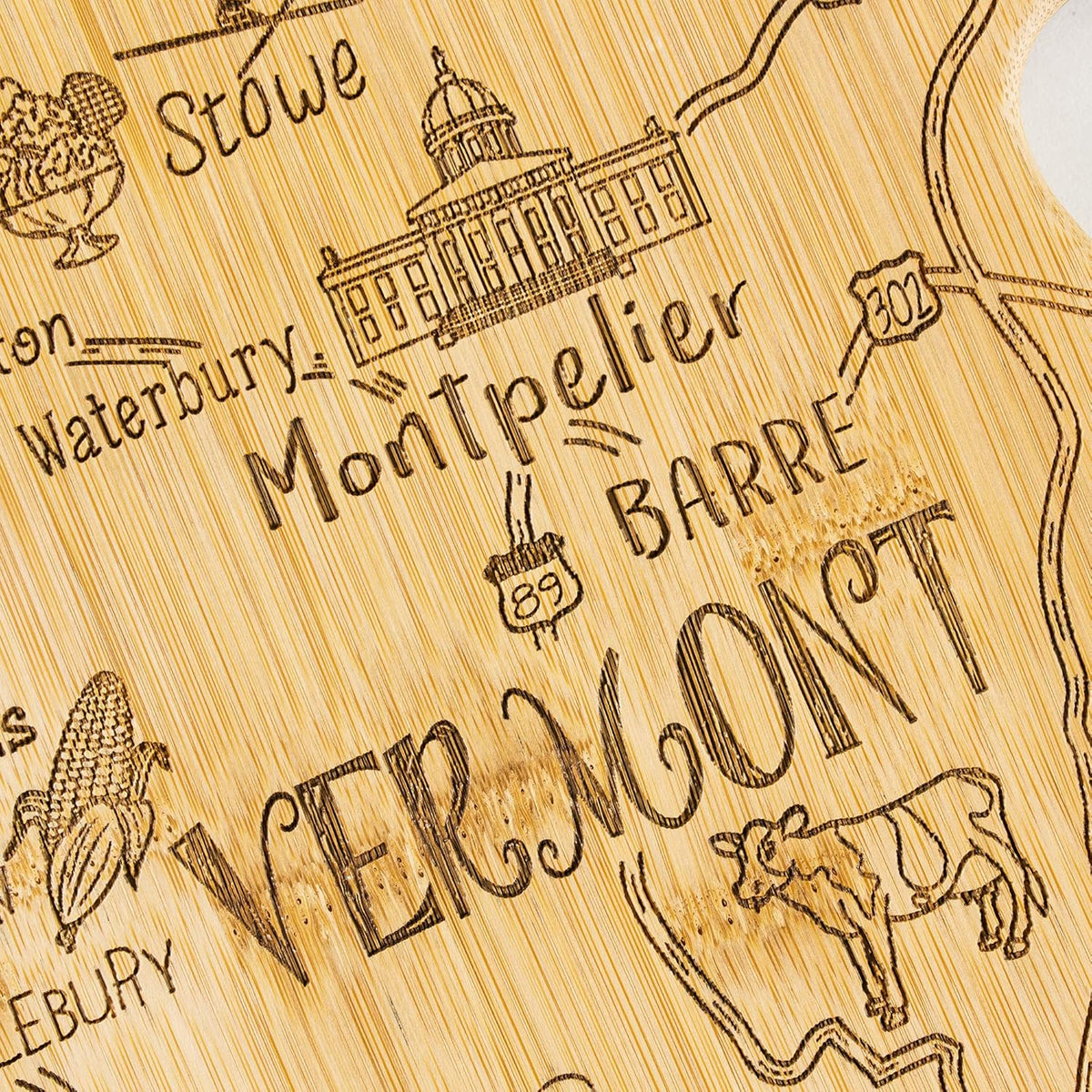 Destination Vermont State Shaped Cutting Board | State charcuterie serving board with engraved map artwork. Smooth reverse side for food prep. Hang tie for wall display.