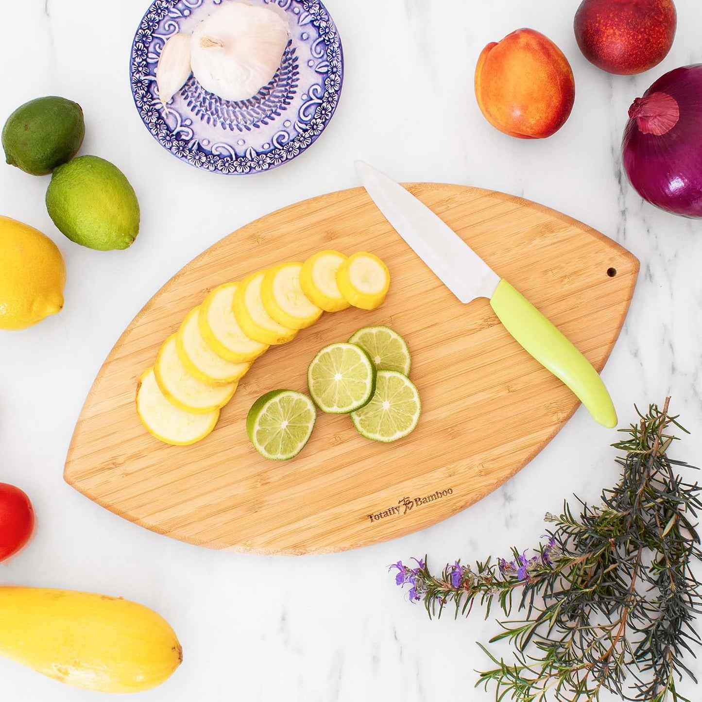 Football Shaped Bamboo Wood Cutting Board and Charcuterie Board, Great Gift for Football Fans | Football serving board for game day watch parties and tailgating. Smooth reverse side for prep. Hangs as decor between uses.