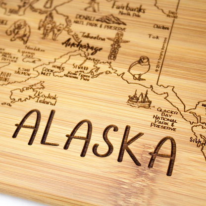 A Slice of Life New Jersey Engraved Map Cutting Board | 11” x 8.75” charcuterie board with engraved state map artwork. Smooth reverse side for food prep. Hang tie for wall display. - Colors B