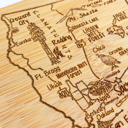 A Slice of Life New Jersey Engraved Map Cutting Board | 11” x 8.75” charcuterie board with engraved state map artwork. Smooth reverse side for food prep. Hang tie for wall display. - Colors B