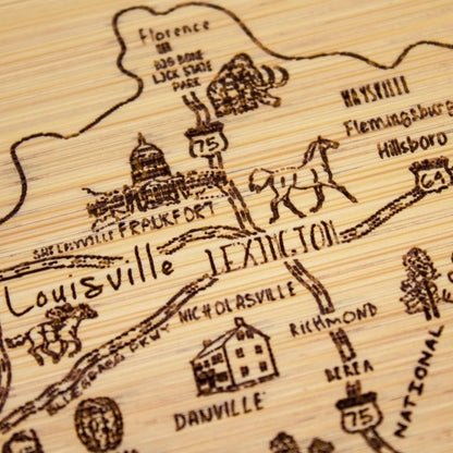 A Slice of Life New Jersey Engraved Map Cutting Board | 11” x 8.75” charcuterie board with engraved state map artwork. Smooth reverse side for food prep. Hang tie for wall display. - Colors B