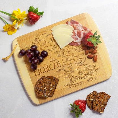 A Slice of Life New Jersey Engraved Map Cutting Board | 11” x 8.75” charcuterie board with engraved state map artwork. Smooth reverse side for food prep. Hang tie for wall display. - Colors B