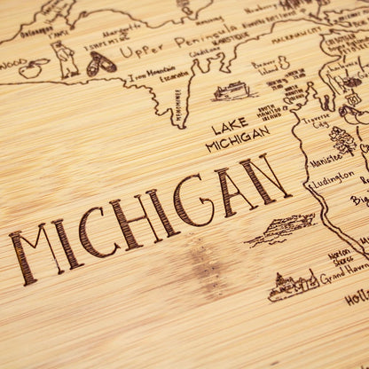 A Slice of Life New Jersey Engraved Map Cutting Board | 11” x 8.75” charcuterie board with engraved state map artwork. Smooth reverse side for food prep. Hang tie for wall display. - Colors B