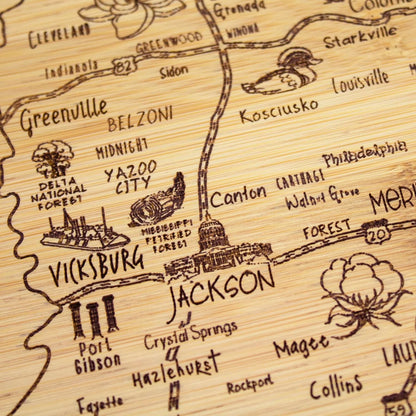 A Slice of Life New Jersey Engraved Map Cutting Board | 11” x 8.75” charcuterie board with engraved state map artwork. Smooth reverse side for food prep. Hang tie for wall display. - Colors B
