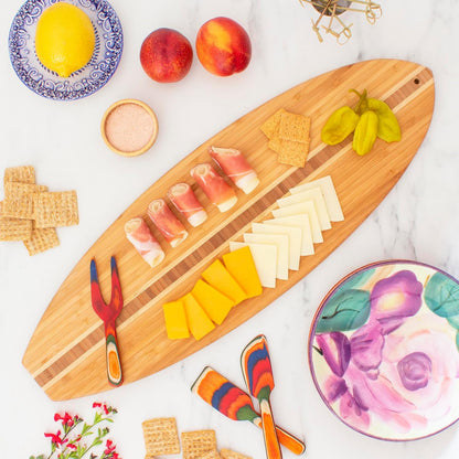 Lil Surfer Small Surfboard Cutting Board, 14.5 x 6 in | Small surfboard-shaped serving board brings beach vibes to charcuterie and snacks. Hang tie for easy wall display.