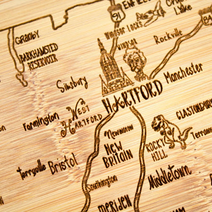 A Slice of Life New Jersey Engraved Map Cutting Board | 11” x 8.75” charcuterie board with engraved state map artwork. Smooth reverse side for food prep. Hang tie for wall display. - Colors A