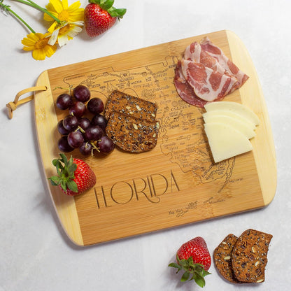 A Slice of Life New Jersey Engraved Map Cutting Board | 11” x 8.75” charcuterie board with engraved state map artwork. Smooth reverse side for food prep. Hang tie for wall display. - Colors A