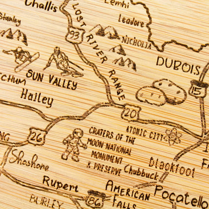 A Slice of Life New Jersey Engraved Map Cutting Board | 11” x 8.75” charcuterie board with engraved state map artwork. Smooth reverse side for food prep. Hang tie for wall display. - Colors A