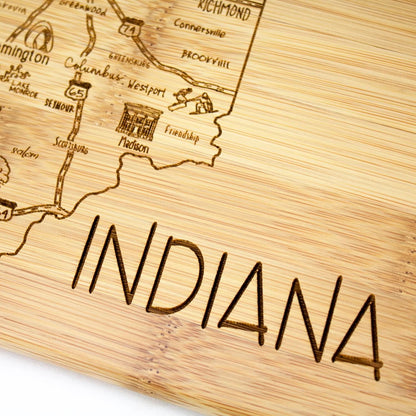 A Slice of Life New Jersey Engraved Map Cutting Board | 11” x 8.75” charcuterie board with engraved state map artwork. Smooth reverse side for food prep. Hang tie for wall display. - Colors A
