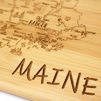 A Slice of Life New Jersey Engraved Map Cutting Board | 11” x 8.75” charcuterie board with engraved state map artwork. Smooth reverse side for food prep. Hang tie for wall display. - Colors A