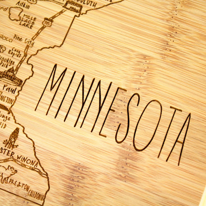 A Slice of Life New Jersey Engraved Map Cutting Board | 11” x 8.75” charcuterie board with engraved state map artwork. Smooth reverse side for food prep. Hang tie for wall display. - Colors A