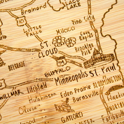 A Slice of Life New Jersey Engraved Map Cutting Board | 11” x 8.75” charcuterie board with engraved state map artwork. Smooth reverse side for food prep. Hang tie for wall display. - Colors A