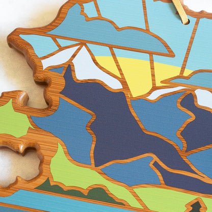 North Carolina State Shaped Cutting Board, Summer Stokes Art | State charcuterie board with colorful hand-drawn landscape art. Smooth reverse side for food prep. Hang tie for wall display. - Colors B