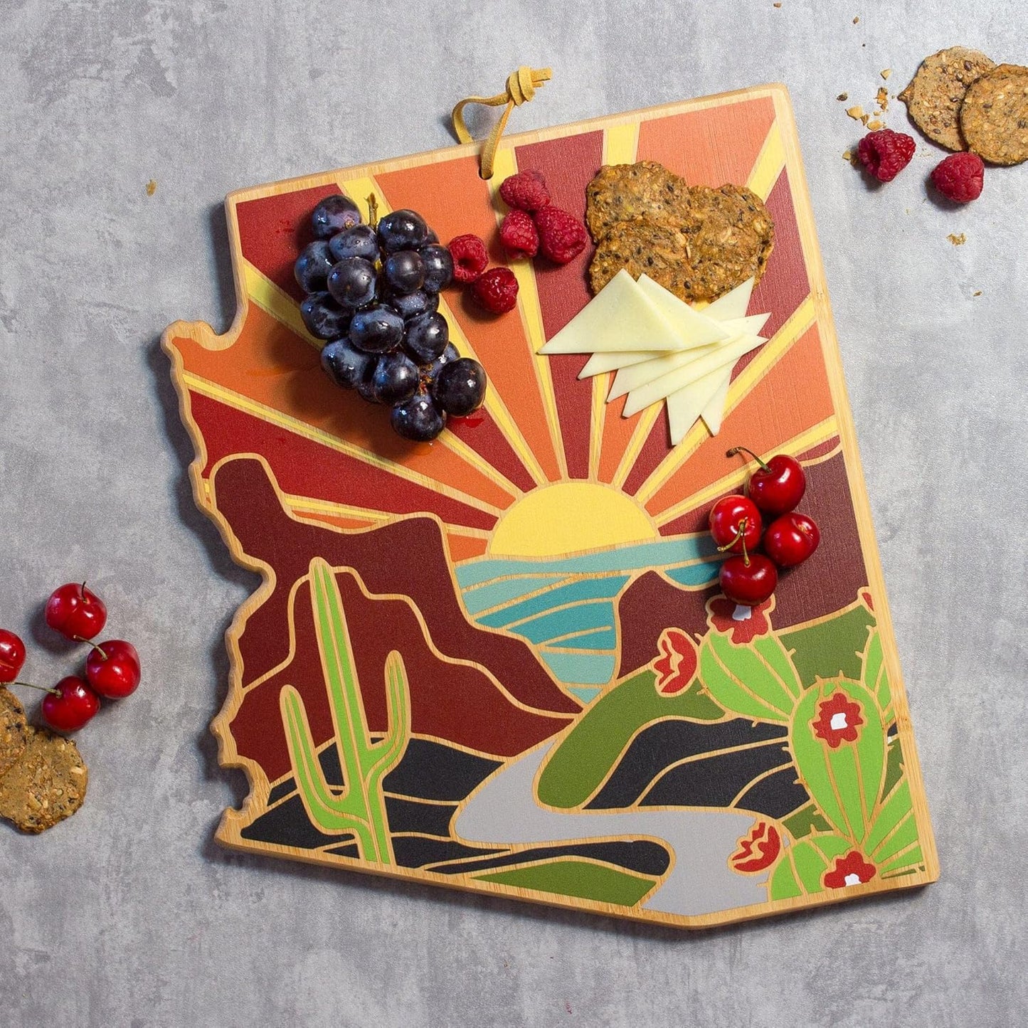 North Carolina State Shaped Cutting Board, Summer Stokes Art | State charcuterie board with colorful hand-drawn landscape art. Smooth reverse side for food prep. Hang tie for wall display. - Colors B