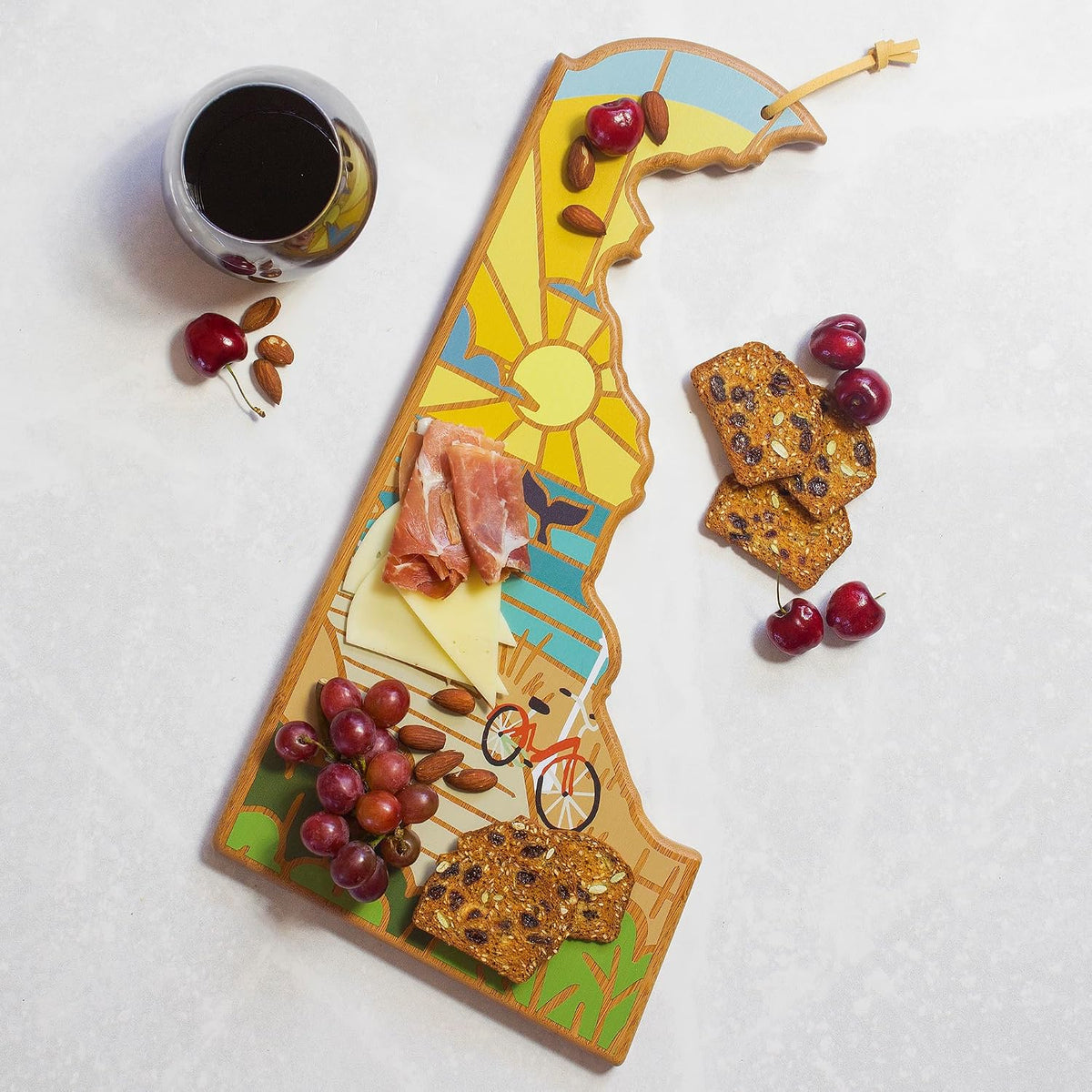 North Carolina State Shaped Cutting Board, Summer Stokes Art | State charcuterie board with colorful hand-drawn landscape art. Smooth reverse side for food prep. Hang tie for wall display. - Colors B