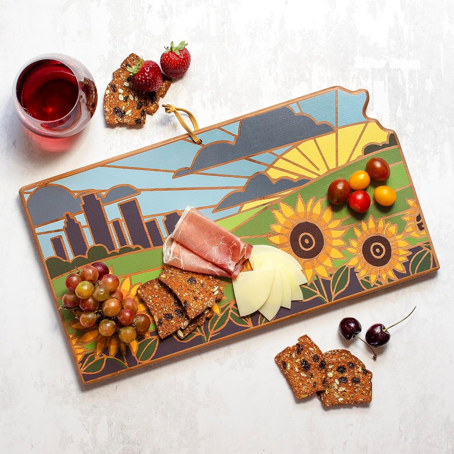 North Carolina State Shaped Cutting Board, Summer Stokes Art | State charcuterie board with colorful hand-drawn landscape art. Smooth reverse side for food prep. Hang tie for wall display. - Colors B