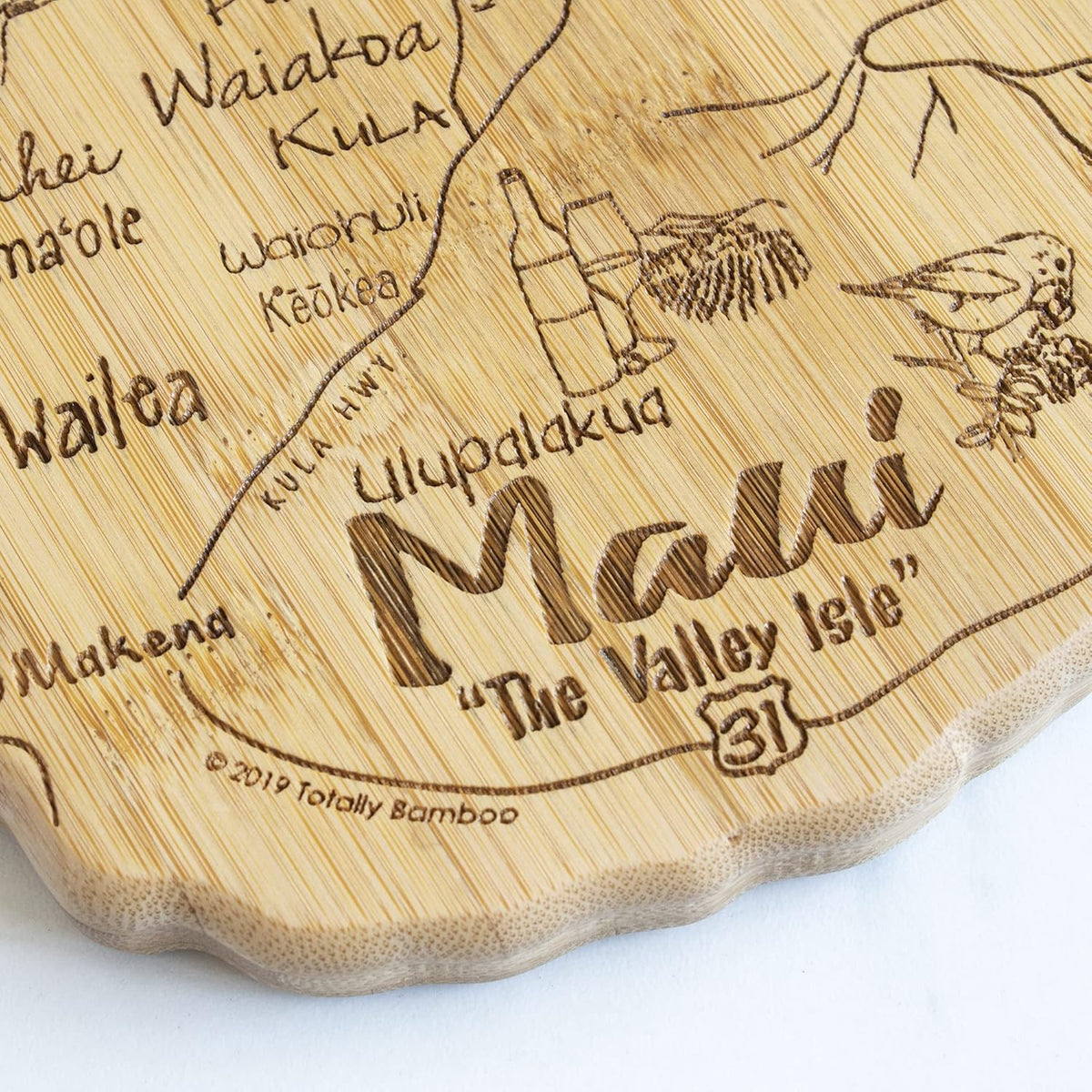 Destination Maui Serving and Cutting Board, Includes Hang Tie for Wall Display | Maui charcuterie serving board with engraved map artwork. Smooth reverse side for food prep. Hang tie for wall display.