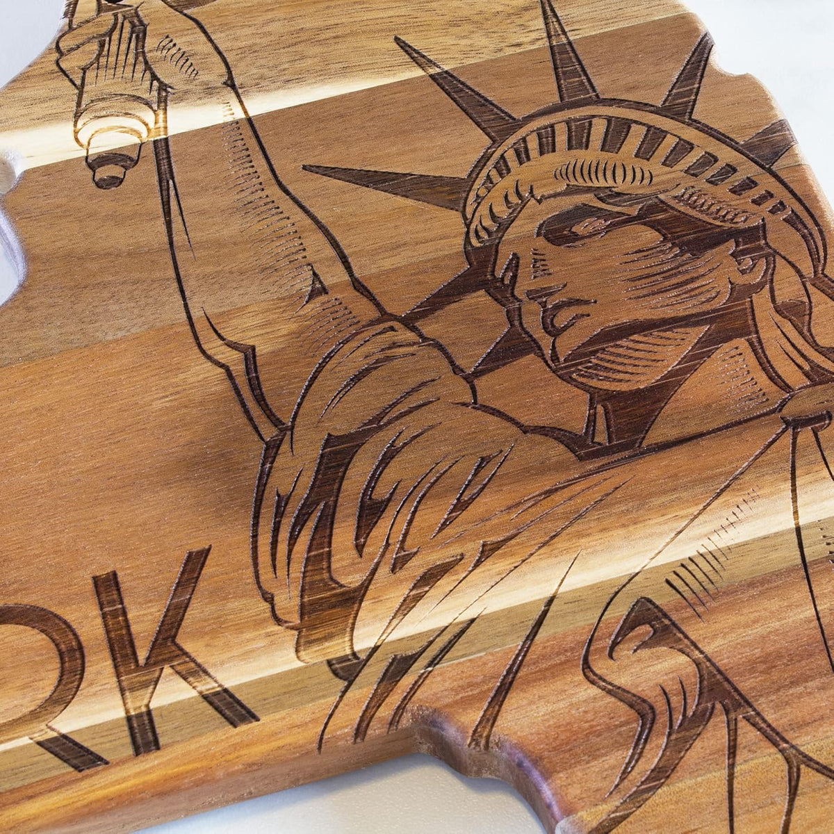 Rock & Branch Origins New York State Shaped Wood Cutting Board | State charcuterie board with bold engraved artwork. Smooth reverse side for food prep. Hang tie for wall display.