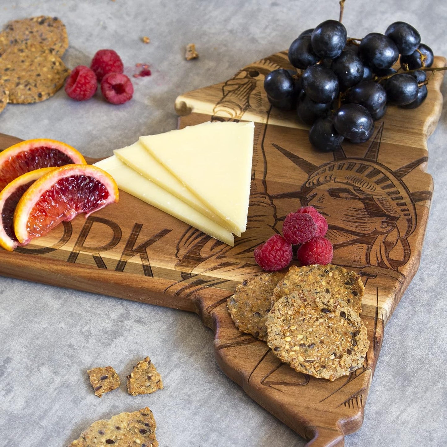 Rock & Branch Origins New York State Shaped Wood Cutting Board | State charcuterie board with bold engraved artwork. Smooth reverse side for food prep. Hang tie for wall display.