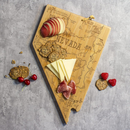 Destination Nevada State Shaped Cutting Board | State charcuterie serving board with engraved map artwork. Smooth reverse side for food prep. Hang tie for wall display.