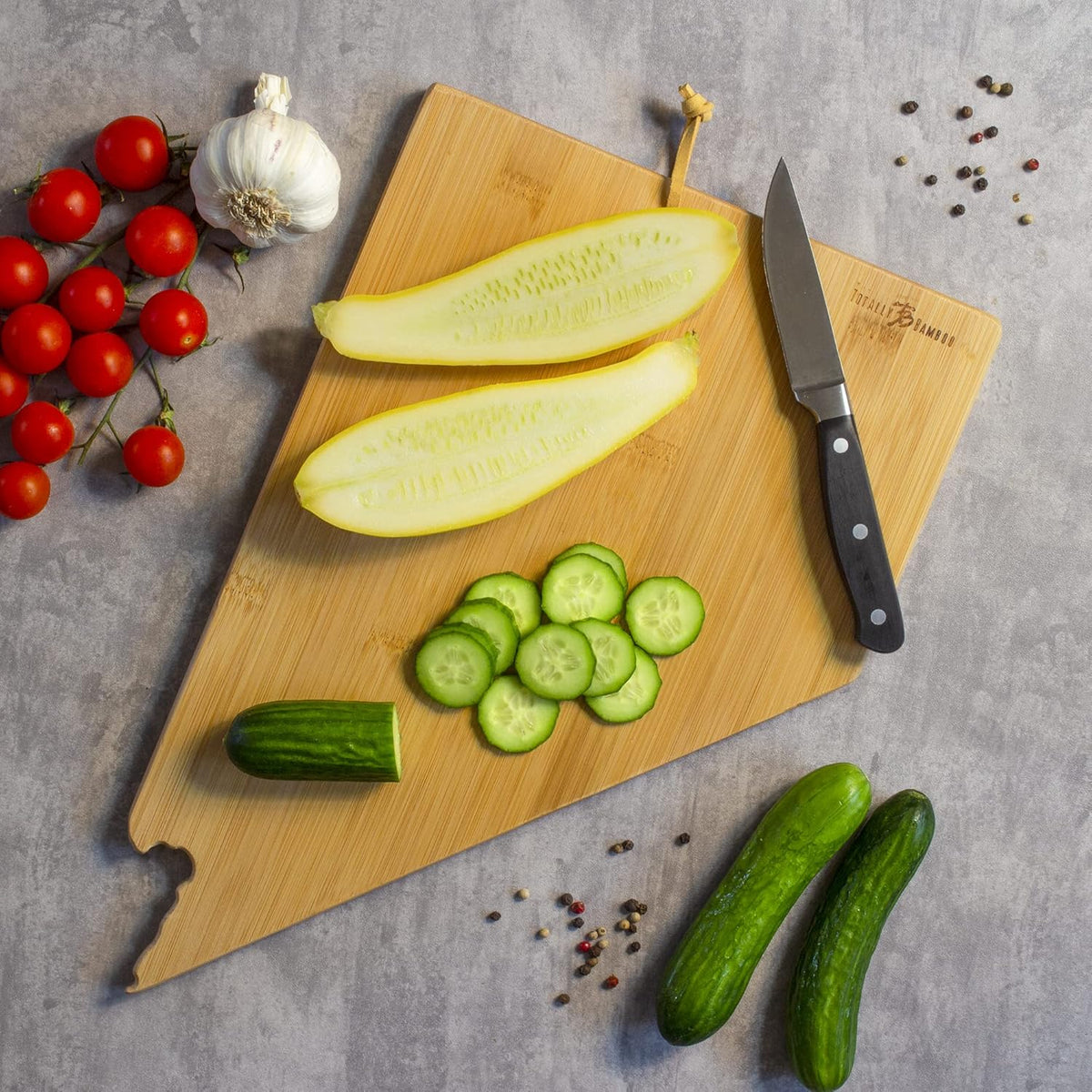 Destination Nevada State Shaped Cutting Board | State charcuterie serving board with engraved map artwork. Smooth reverse side for food prep. Hang tie for wall display.