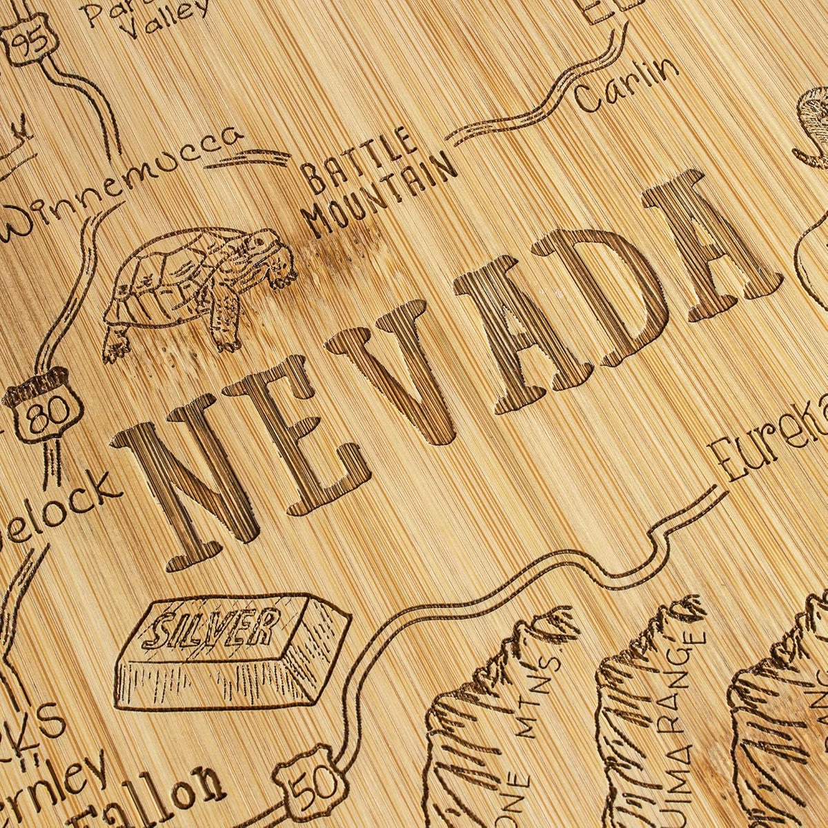 Destination Nevada State Shaped Cutting Board | State charcuterie serving board with engraved map artwork. Smooth reverse side for food prep. Hang tie for wall display.