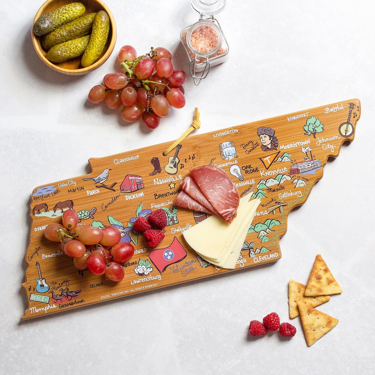 Tennessee State Shaped Cutting Board, Art by Fish Kiss | State charcuterie board with colorful hand-drawn map artwork. Smooth reverse side for food prep. Hang tie for wall display. - Colors B