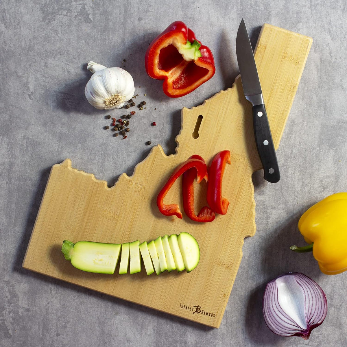 Tennessee State Shaped Cutting Board, Art by Fish Kiss | State charcuterie board with colorful hand-drawn map artwork. Smooth reverse side for food prep. Hang tie for wall display. - Colors B