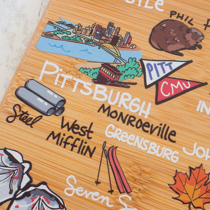 Tennessee State Shaped Cutting Board, Art by Fish Kiss | State charcuterie board with colorful hand-drawn map artwork. Smooth reverse side for food prep. Hang tie for wall display. - Colors B