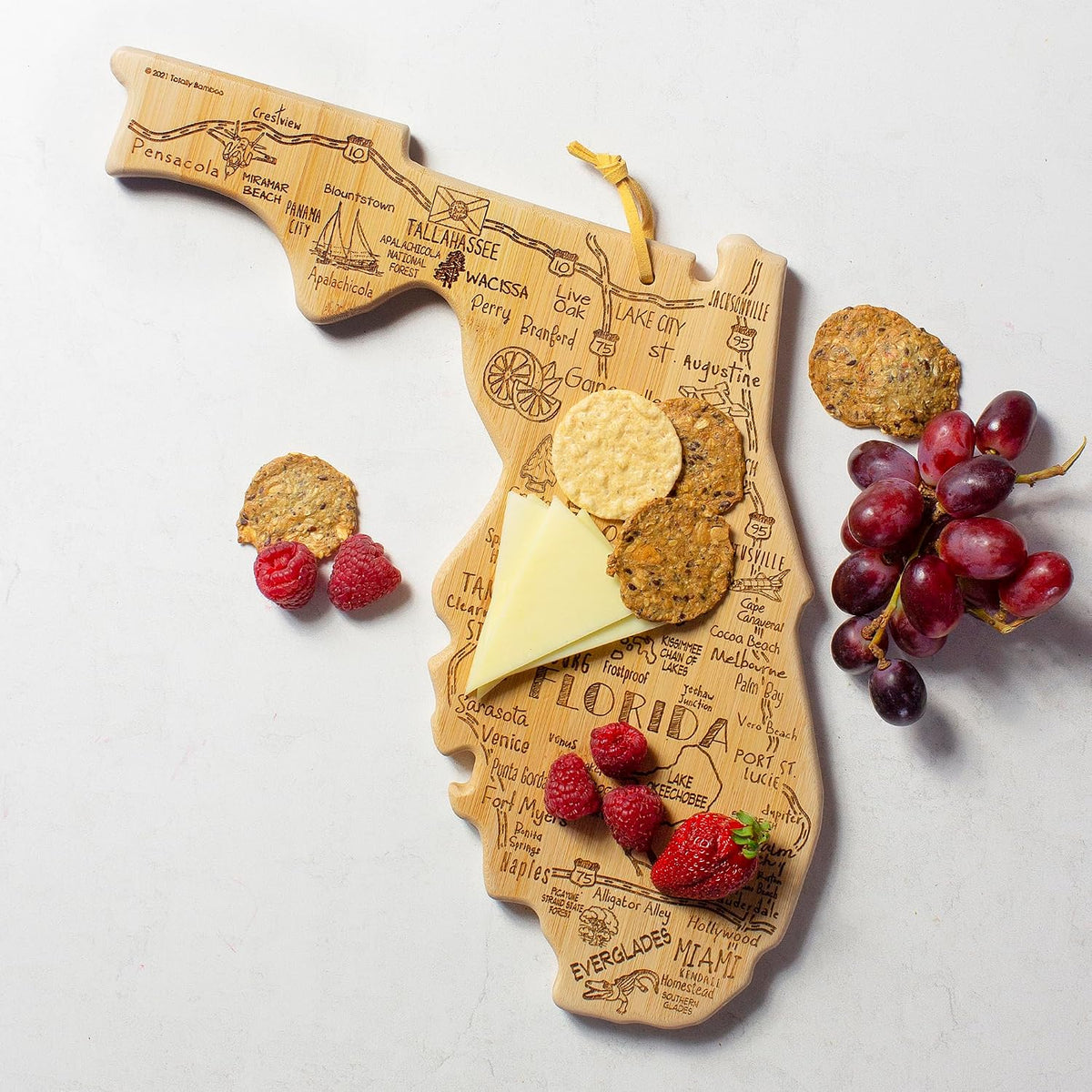 Destination Florida State Shaped Cutting Board | State charcuterie serving board with engraved map artwork. Smooth reverse side for food prep. Hang tie for wall display.